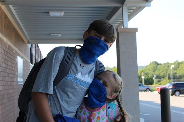 parent and student smile on first day back to school